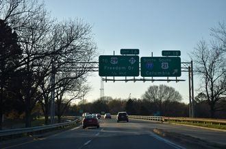 I-277/US 74 west at I-77/US 21 south to Columbia, SC.