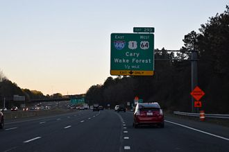 I-40 heads southeast into the cloverleaf interchange with I-440/US 1-64 (Cliff Benson Beltline).