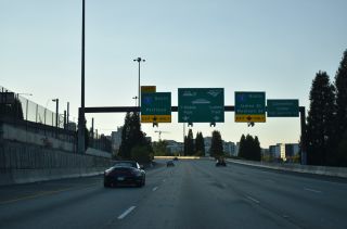 Westbound I-90 arcs northward from Rainer Ave to I-5 in Seattle, Washington