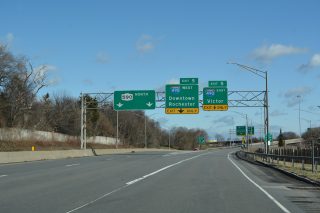 Two lanes depart from I-590 north for I-490 at the Can of Worms Interchange.