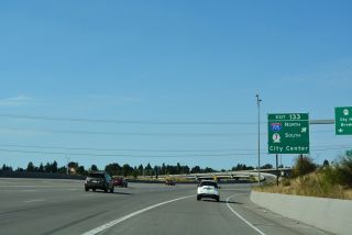An HOV exit departs I-5 north for SR 16 across from Exit 133 to I-705